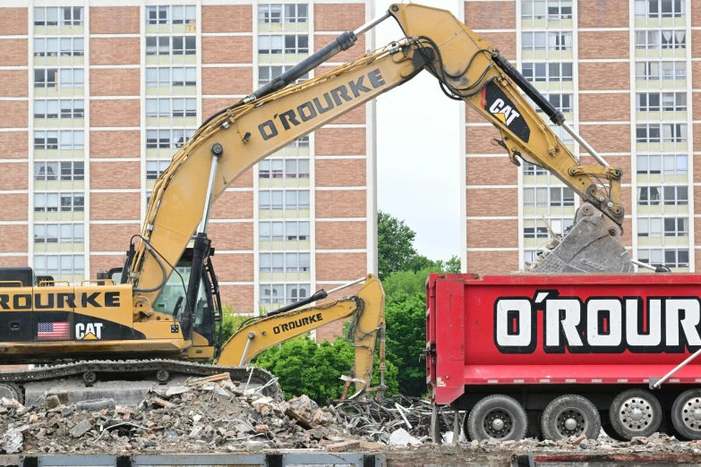 a dump truck is towing a construction equipment