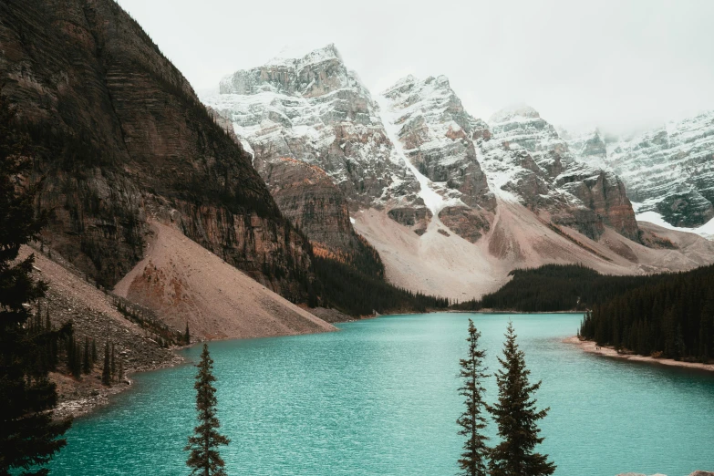 there are mountains in the distance and lake in the foreground