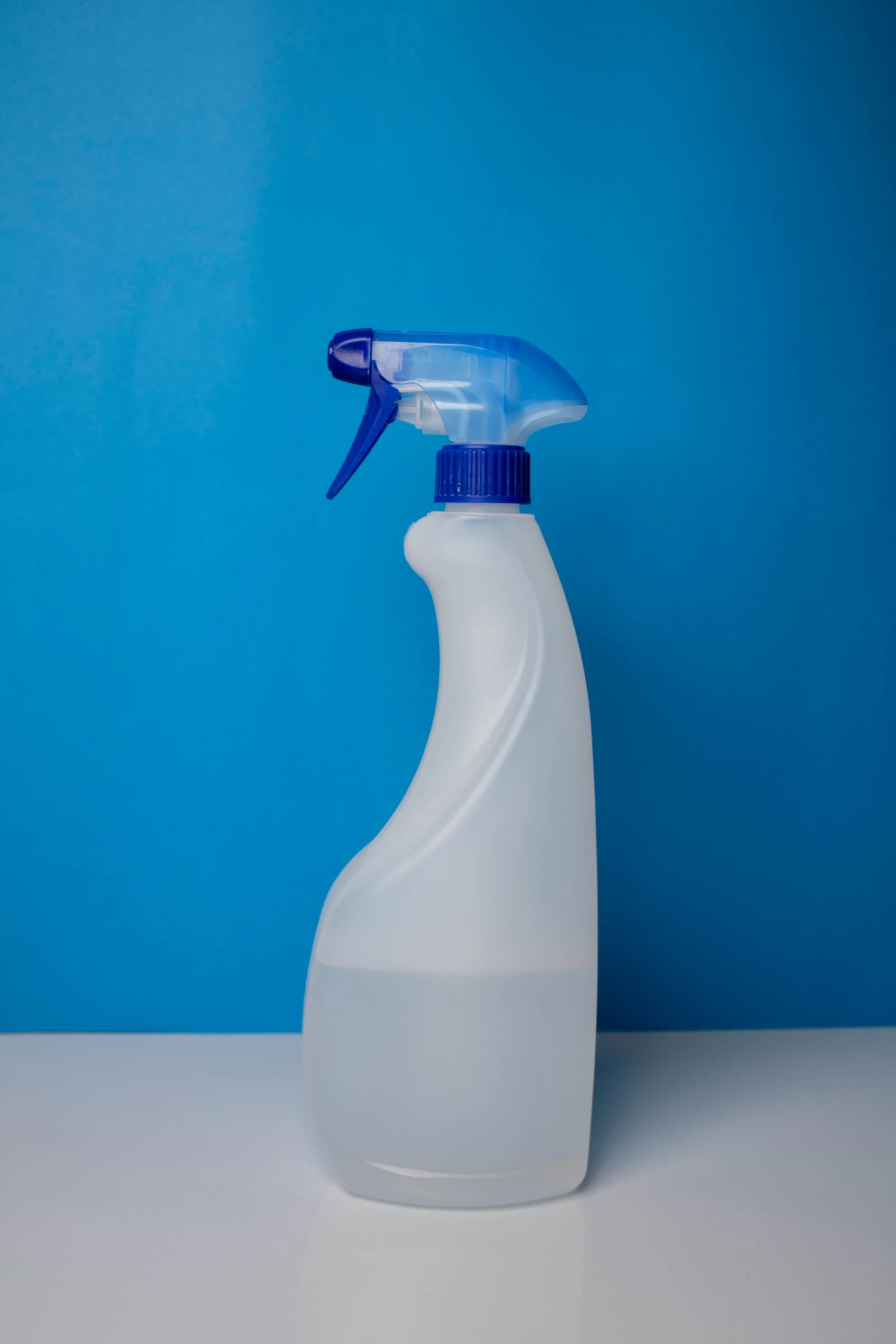 a bottle with a blue top sitting on a counter