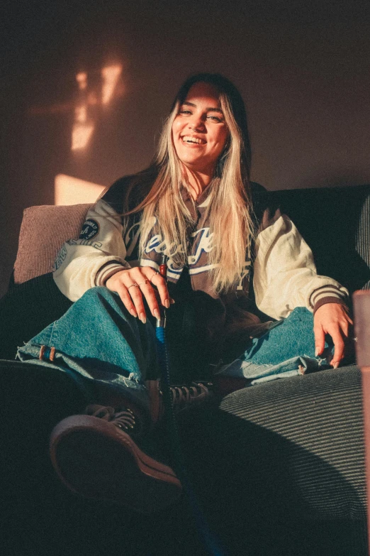 a woman sitting on a couch with a glass of wine