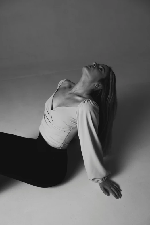 a woman on one side of her body with her eyes closed while laying on the floor