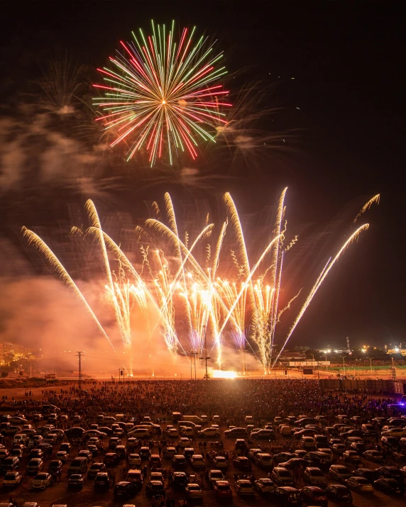 a large field full of cars covered in lights