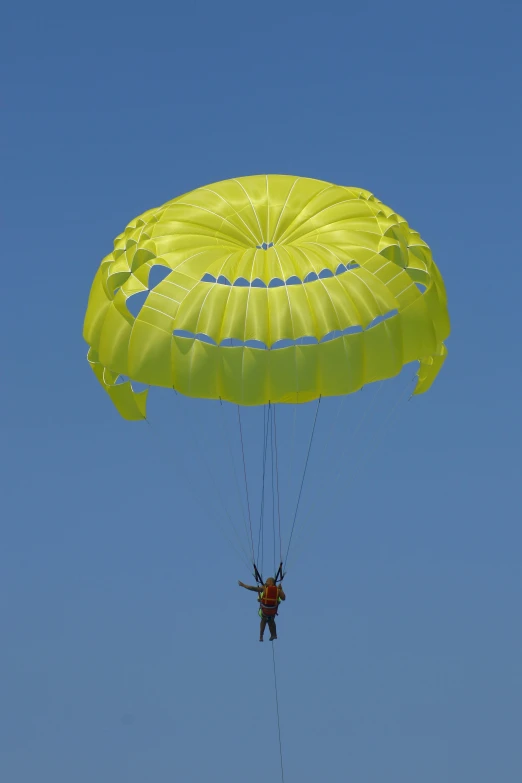 a man that is in the air with a parachute