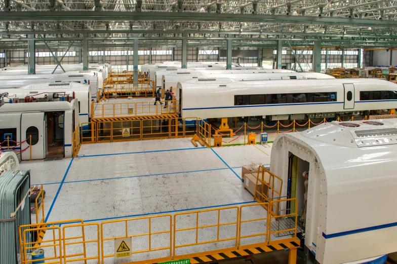 a bunch of buses parked in a large building