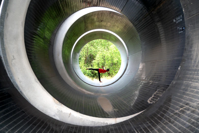 a large metal tube in the middle of a walkway