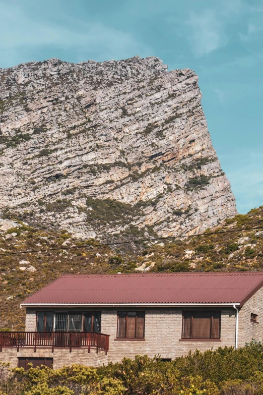 a house sitting at the base of a hill