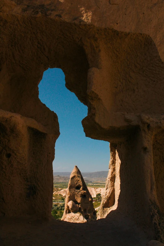 looking into an open, crumbling stone wall near the mountains