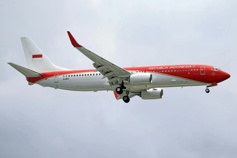 a large passenger jet flying through a cloudy sky