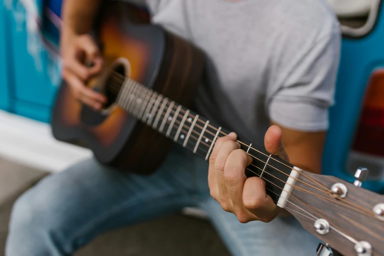 a man with an ukulele sitting on a bus