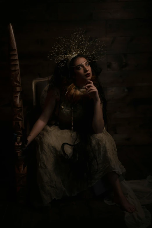 a woman with freckled hair sitting in a chair