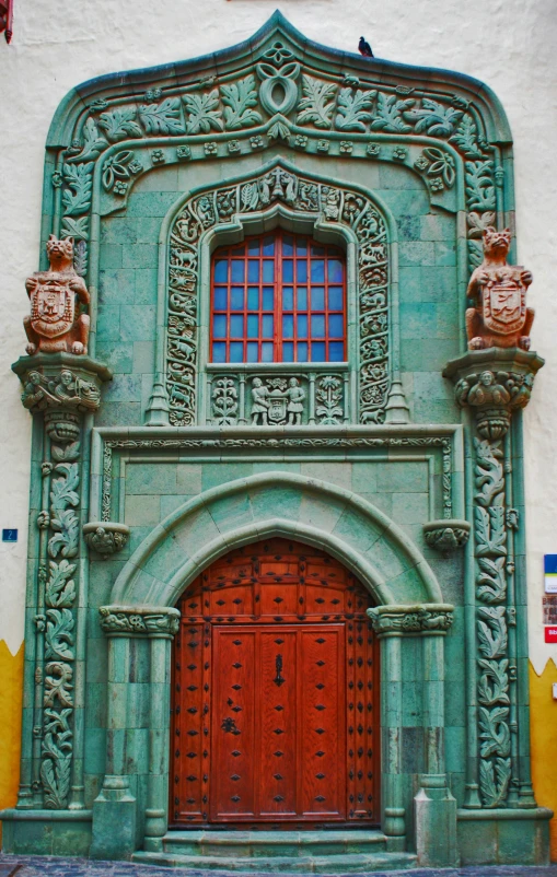 an old building with a green stone front