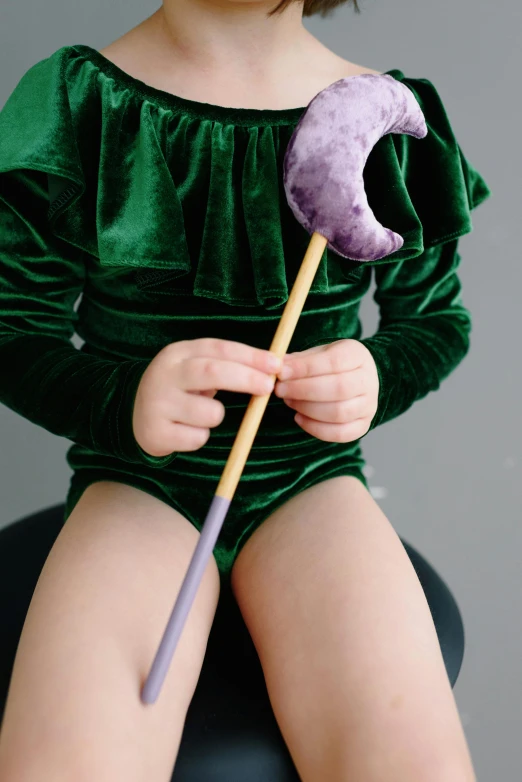 a  in green with a purple toothbrush