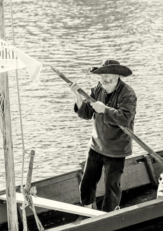 a man in a hat and jacket getting on a boat