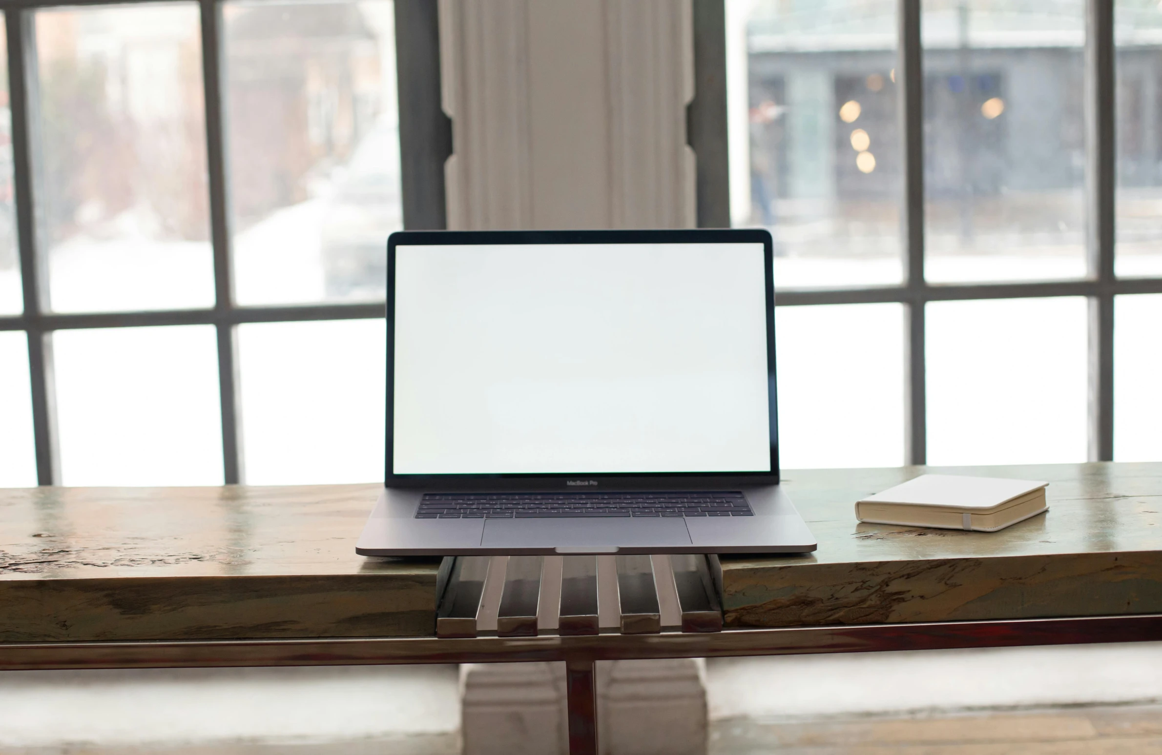 a laptop sits on top of a wooden bench