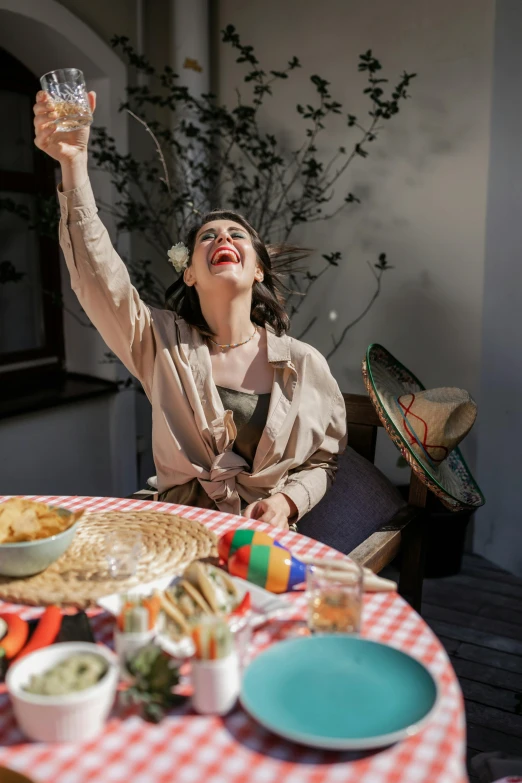 woman holding glass with food on top of table