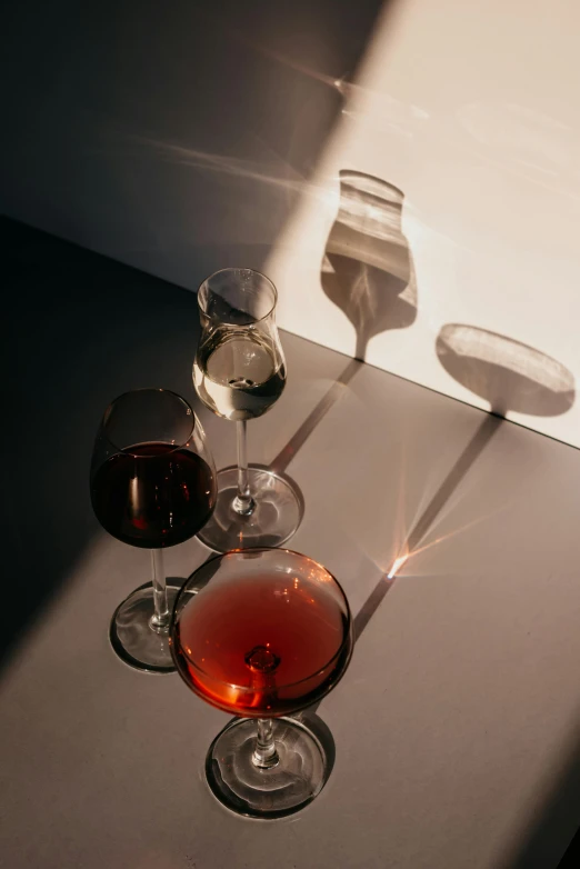 a table with some wine glasses and three plates