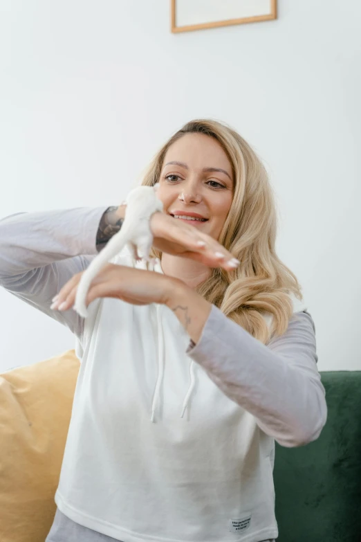 a woman holding a toy monkey while sitting on a couch