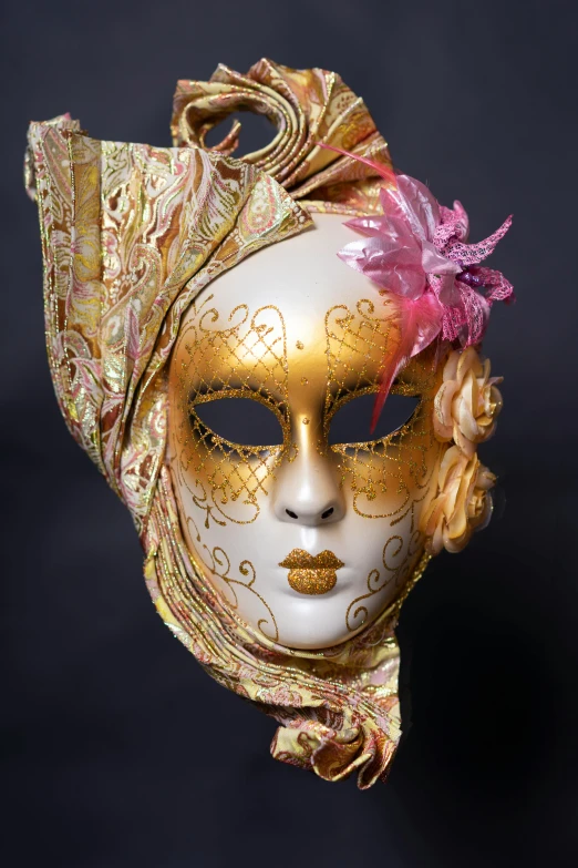 a golden mask has gold embellishments on it