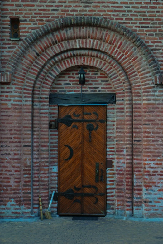 an artistic wooden door in front of an archway