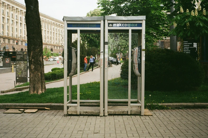 a couple of open cellphones sit in a sidewalk