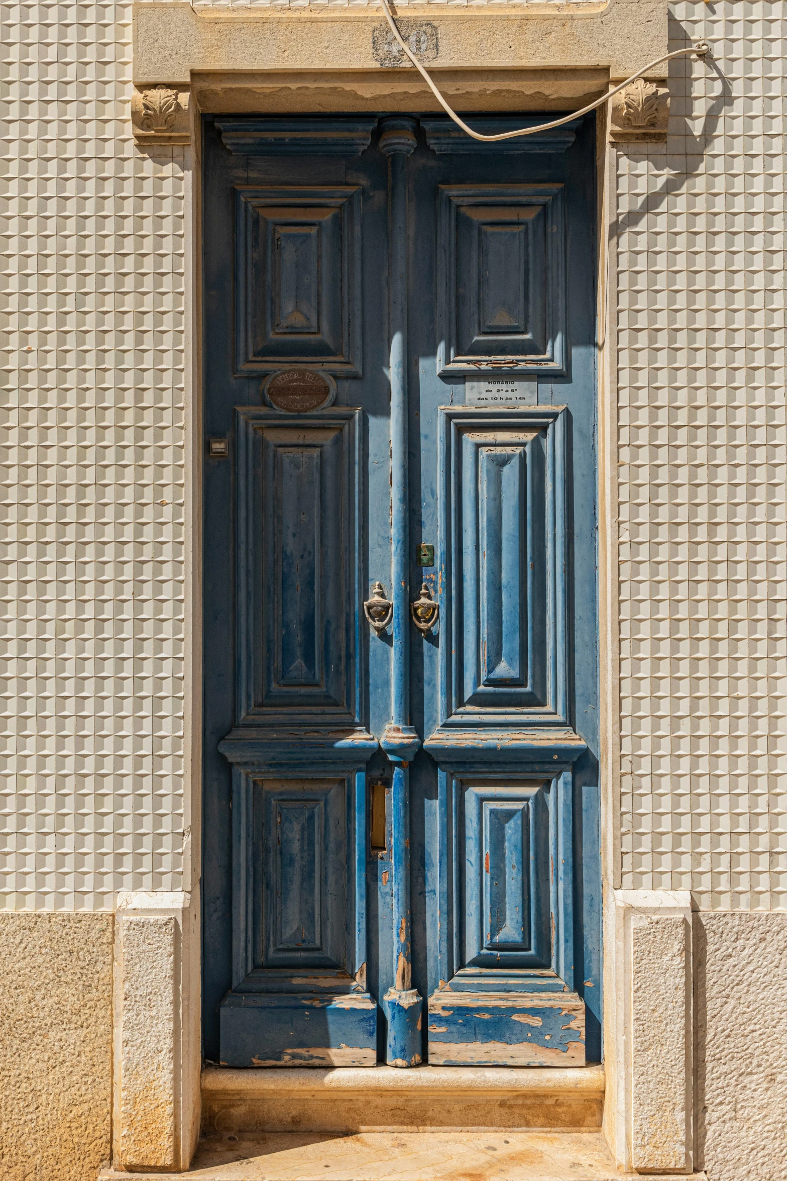 blue doors and a lamp on an urban building