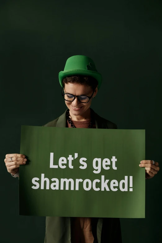 a woman is holding a sign saying let's get shamrock - blocked
