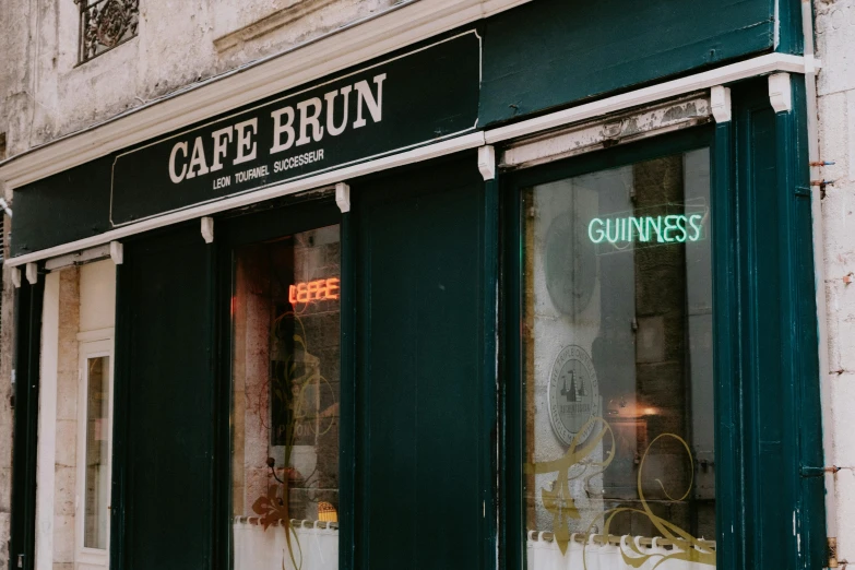 a cafe with closed signs and green windows