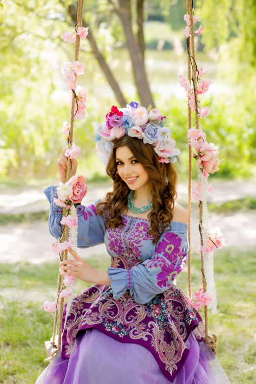 an asian girl dressed up like raptang sitting on a swing in a park