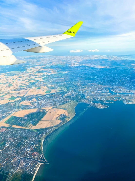 a plane that is flying over water on the sky