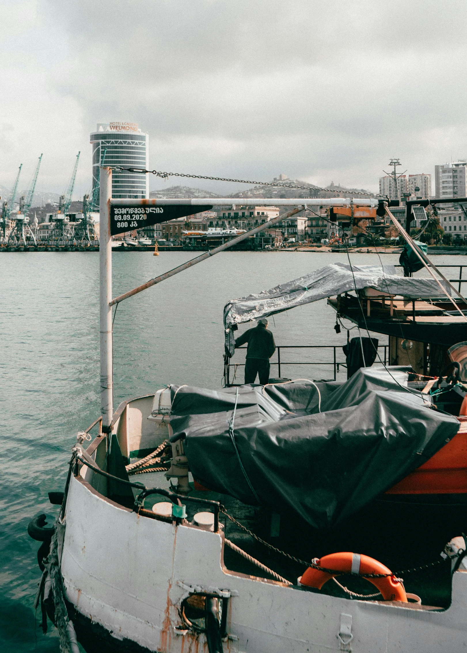 the back of a boat with covers on it docked in the water