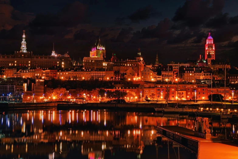 a large city with a tall clock tower at night