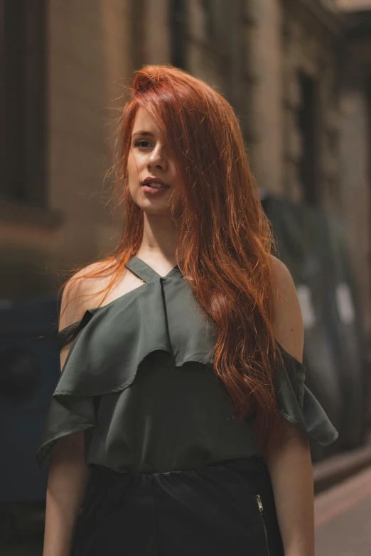 a woman with red hair and large  wearing a black blouse