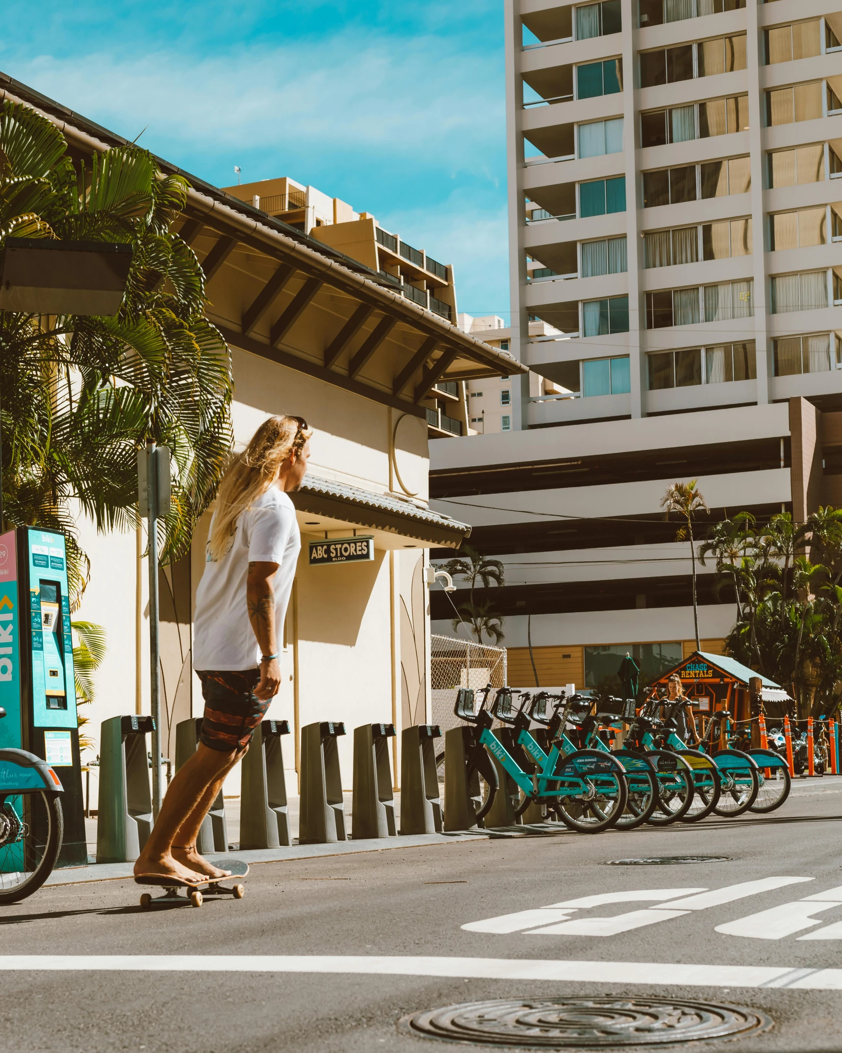 the woman in shorts is riding her skateboard down the street