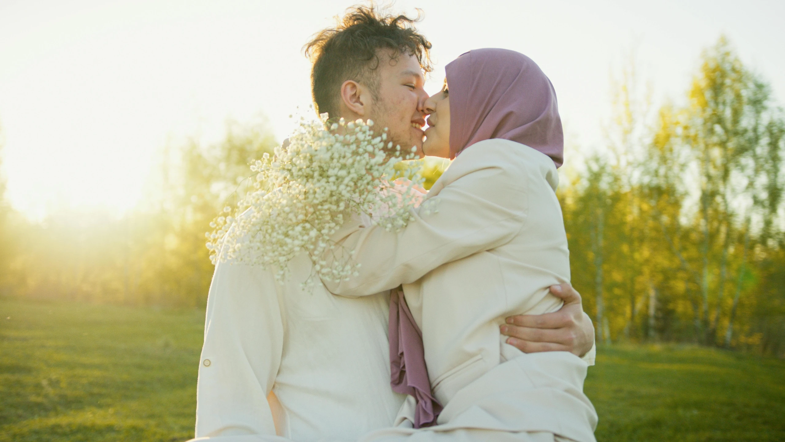 two people sit next to each other with flowers growing out of their mouths