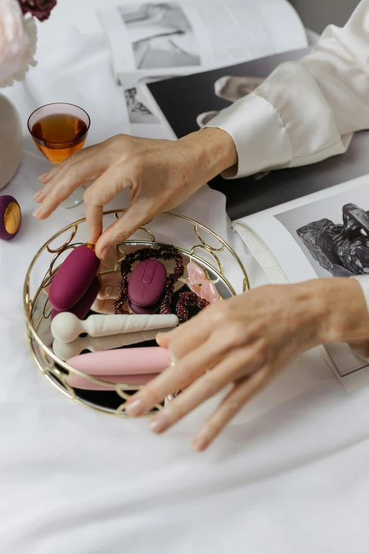 a person is holding a plate of knicky knacks and pointing to the center