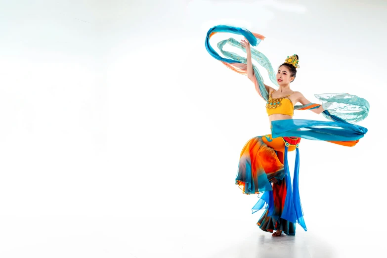 a person standing in a white room holding soing blue and orange