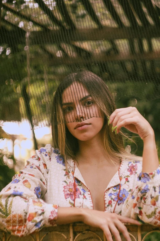 the young woman is posing in the garden