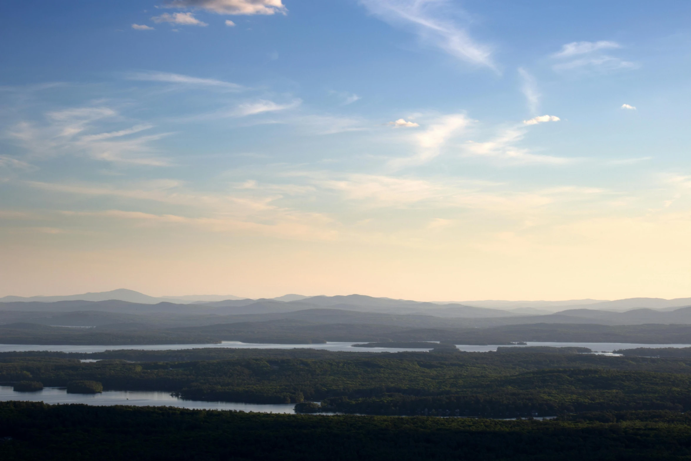 lake in an open area with mountains and clouds