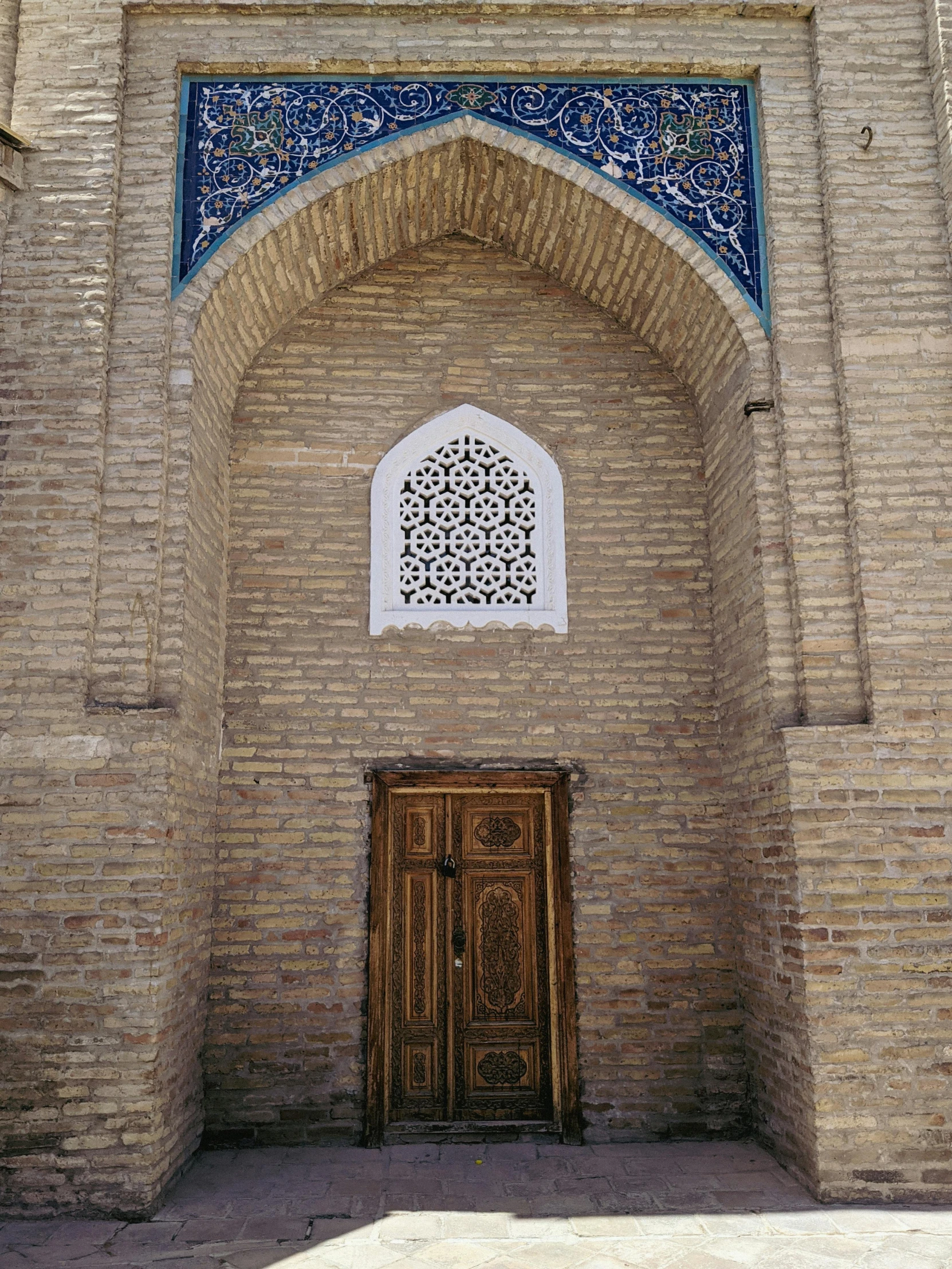 a large arch opening to a building with a doorway