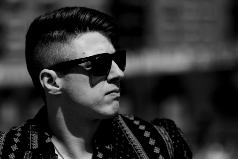 a young man wearing sunglasses in a black and white po