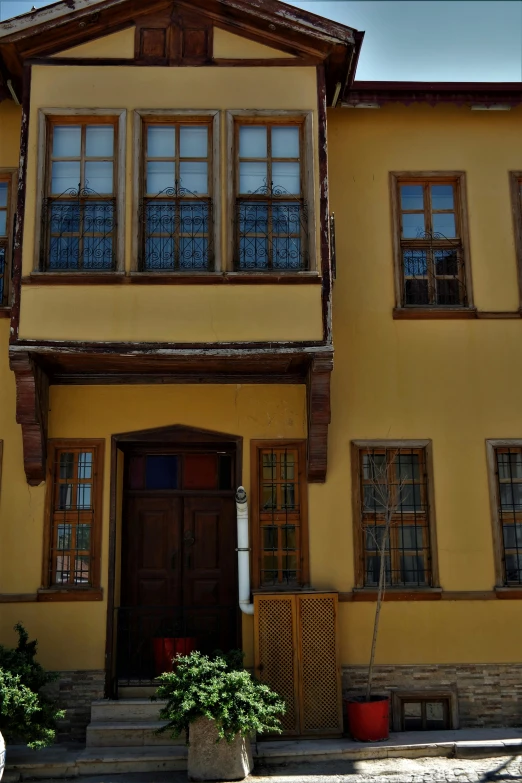 an old house has two stories and three large windows