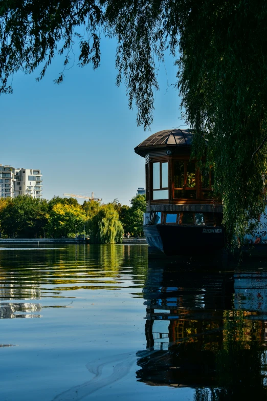 a boat sitting on the water by a bridge