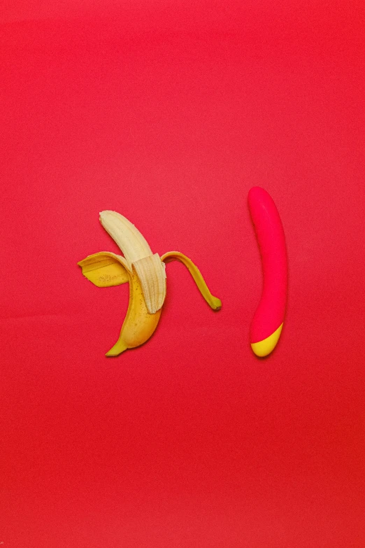 a banana split in half with a yellow peel lying on it