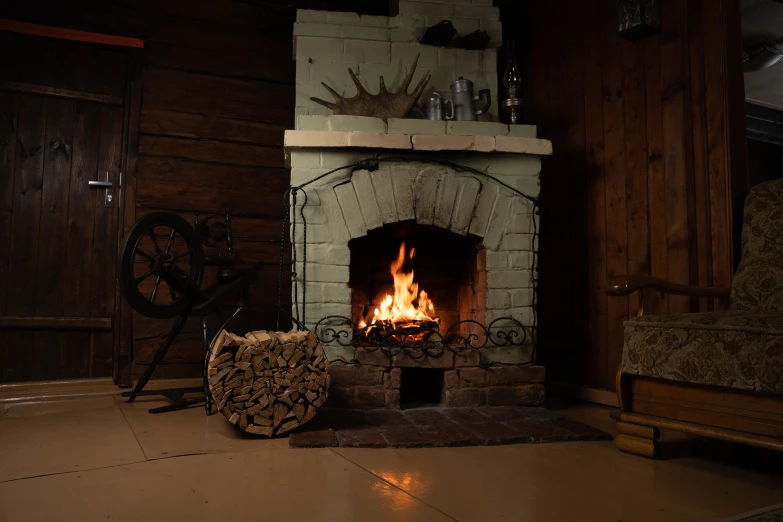 a living area with a fire and a firewood stove