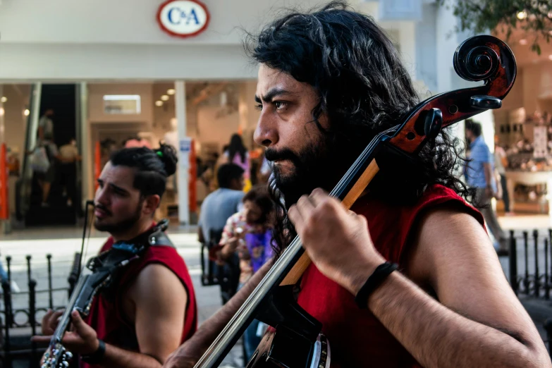 a man with a long beard and a very long hair holding a guitar