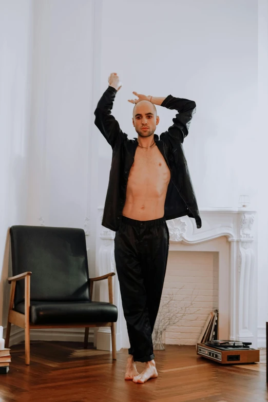 a man standing on top of a hard wood floor