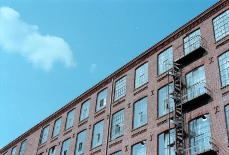 a fire escape is going through the windows of an old brick building