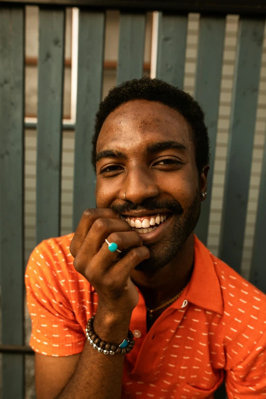 a man wearing a colorful shirt and smiling