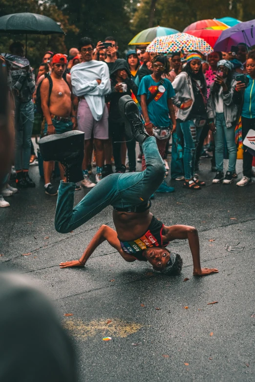 a man in a green hat doing somersard on the ground