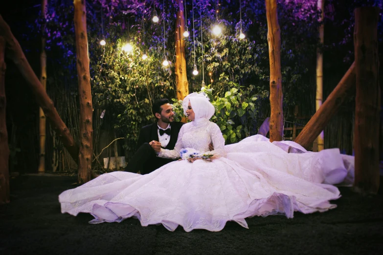 man and woman dressed in wedding attire standing next to each other